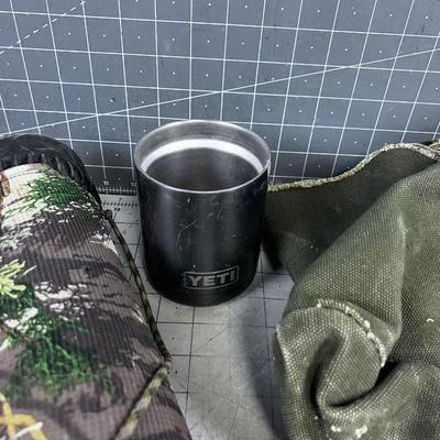 Mixed Lot of Outdoor Gear; Pouches, Tent Pegs, Elk Call, Yeti Cup, Solar Charger