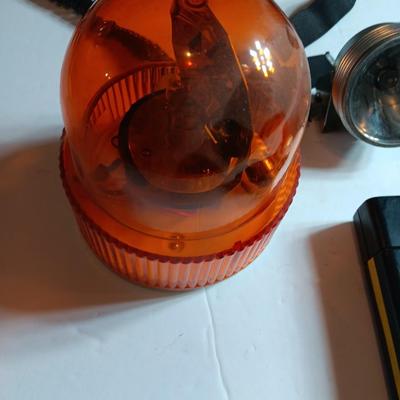 Orange security warning flasher / siren light with vintage metal battery operated head lamp and flashlight.