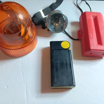 Orange security warning flasher / siren light with vintage metal battery operated head lamp and flashlight.