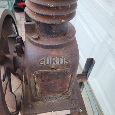 Antiques Curtis compressor on stand with wheels.