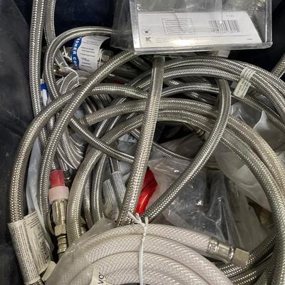 Tub full of flexible fawcett hoses & other plumbing components