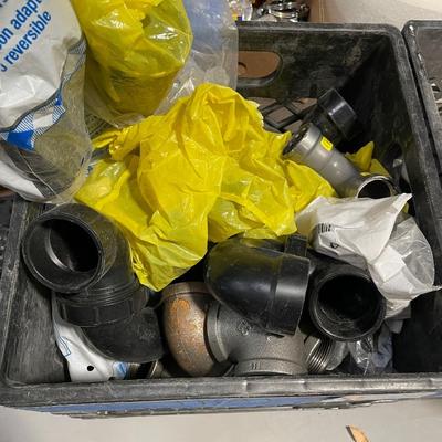 Crate of various plumbing pipe pieces - plastic and galvanized P-Traps & more