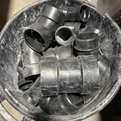 Garbage can full of Black PVC pieces - 45 & 90 degree that look to be 3" & 4" size