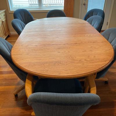 Oval dining room table with blue upholstered chairs