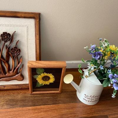 Floral wall decor, pillow and watering can