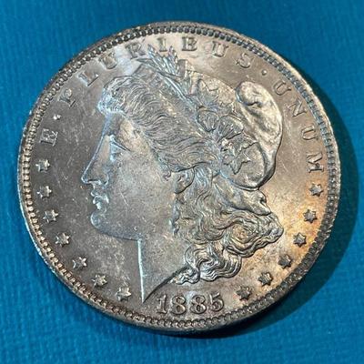 1885-O BU CONDITION MORGAN SILVER DOLLAR AS PICTURED.
