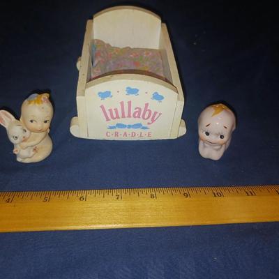 SMALL CERAMIC KEWPIE DOLLS AND A LULLABY CRADLE