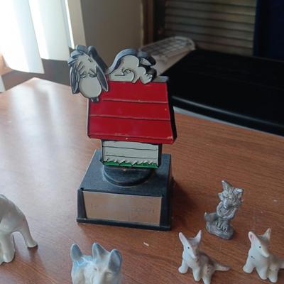 SNOOPY SURROUNDED BY PEWTER AND CERAMIC DOGS