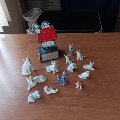 SNOOPY SURROUNDED BY PEWTER AND CERAMIC DOGS