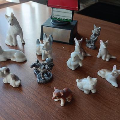 SNOOPY SURROUNDED BY PEWTER AND CERAMIC DOGS