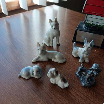 SNOOPY SURROUNDED BY PEWTER AND CERAMIC DOGS