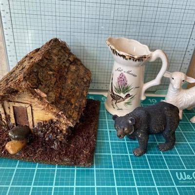 Natural house with bear, lamb and pitcher