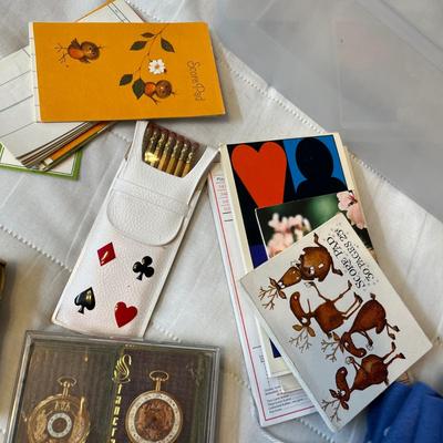 Tub of playing cards & tally sheets.