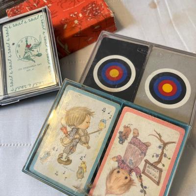 Tub of playing cards & tally sheets.