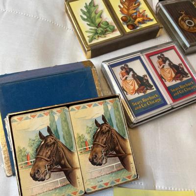 Tub of playing cards & tally sheets.