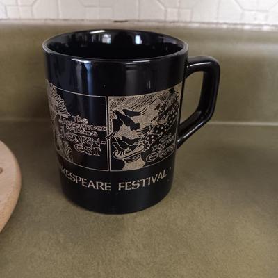 A VARIETY OF COFFEE CUPS AND A CARAFE