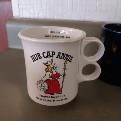 A VARIETY OF COFFEE CUPS AND A CARAFE