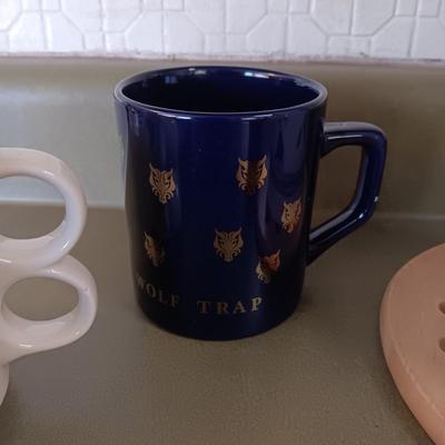 A VARIETY OF COFFEE CUPS AND A CARAFE