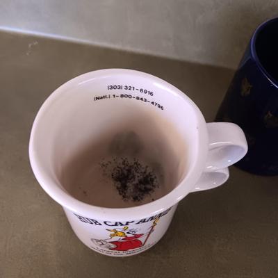 A VARIETY OF COFFEE CUPS AND A CARAFE