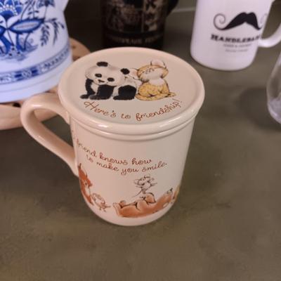 A VARIETY OF COFFEE CUPS AND A CARAFE