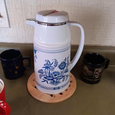 A VARIETY OF COFFEE CUPS AND A CARAFE