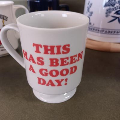 A VARIETY OF COFFEE CUPS AND A CARAFE