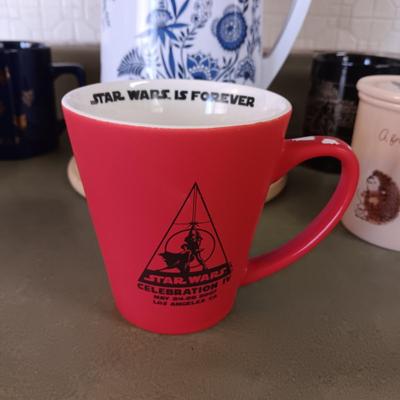 A VARIETY OF COFFEE CUPS AND A CARAFE