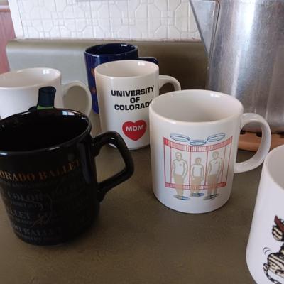 VARIETY OF COFFEE CUPS AND A PERCOLATOR