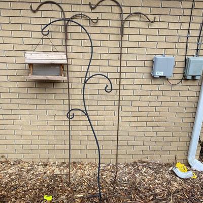 SHEPHERD HOOKS AND A BIRD FEEDER