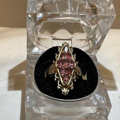 Stamped Ring size 9,, metal two tone, stones are pink in color