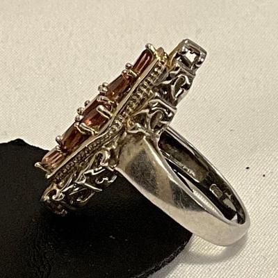 Stamped Ring size 9,, metal two tone, stones are pink in color