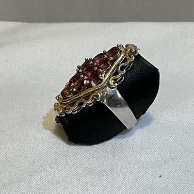 Stamped Ring size 9,, metal two tone, stones are pink in color