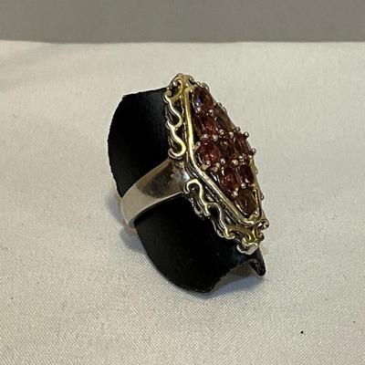 Stamped Ring size 9,, metal two tone, stones are pink in color
