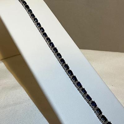 Sterling silver bracelet, stones are blue in color, 7.5in