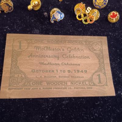 A COLLECTION OF PINS, PATCHES, WOODEN CARD AND WIND UP SKELETON