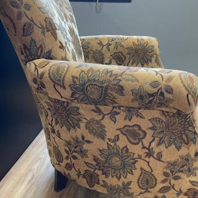 Tan accent chair with vines and leaf design