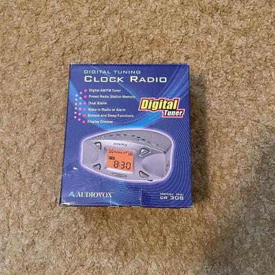 NEW CLOCK RADIO, PORTABLE AM/FM RADIO AND AN AIR PUMP