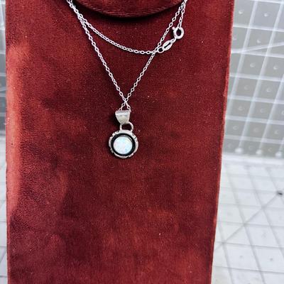 NEAT Looks like the MOON - Opal Pendant on Sterling Siler Chair