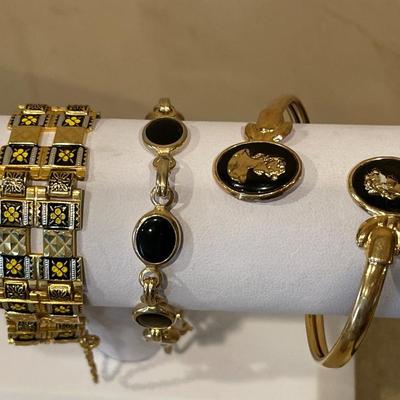 3 black & gold tone bracelets