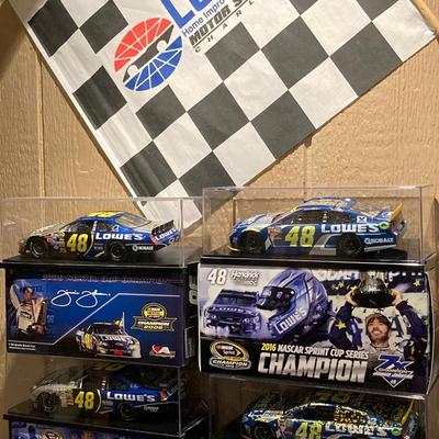LOT 59: NASCAR - Jimmy Johnson #48 Lowe's Motor Speedway Flag and Four Die-Cast 1:24 Scale Race Cars