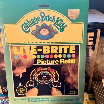 LOT:112: Vintage Lite-Bite in Original Box, pegs, and a Large Collection of Refills Including Mickey Mouse, Gremlins, Snoopy and More
