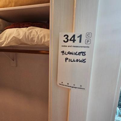 Assorted bed blankets and pillows