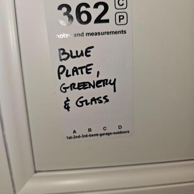 Blue plate, greenery and glass