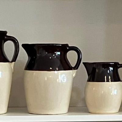 Four Vintage Stoneware Two Tone Pitchers