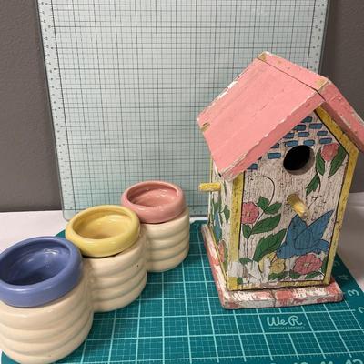 Vintage bird house with flowers and planter