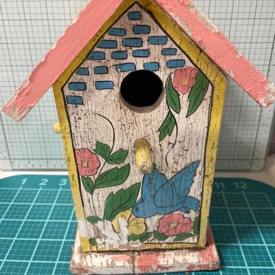 Vintage bird house with flowers and planter
