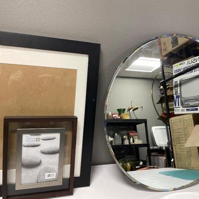 Frames and large round mirror