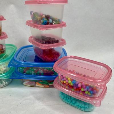 Craft beads in assorted plastic containers