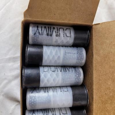 Two boxes of 12 guage dummy loads and another box of plastic bullets