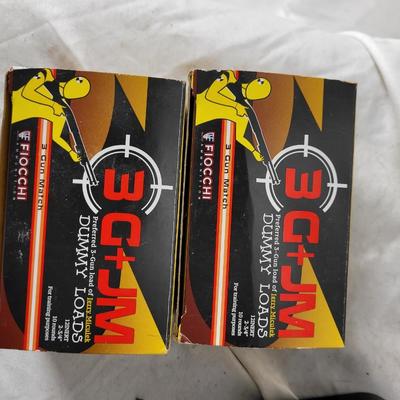 Two boxes of 12 guage dummy loads and another box of plastic bullets